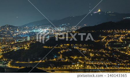 Barcelona and Badalona skyline with roofs of houses and sea on the horizon night timelapse Barcelona and Badalona skyline with roofs of houses and sea on the horizon night timelapse 140143365
