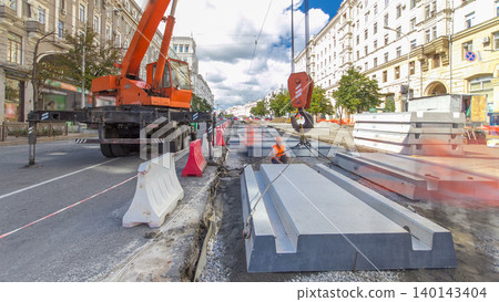 Installing concrete plates by crane at road construction site timelapse hyperlapse. Installing concrete plates by crane at road construction site timelapse hyperlapse. 140143404