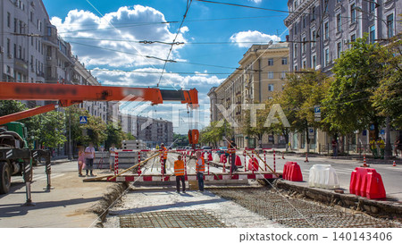 Orange construction telescopic mobile crane moving small pedestrian bridge timelapse. 140143406