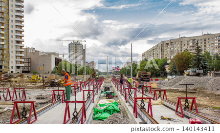 Tram rails at the stage of their installation and integration into concrete plates on the road timelapse. Tram rails at the stage of their installation and integration into concrete plates on the road timelapse. 140143411