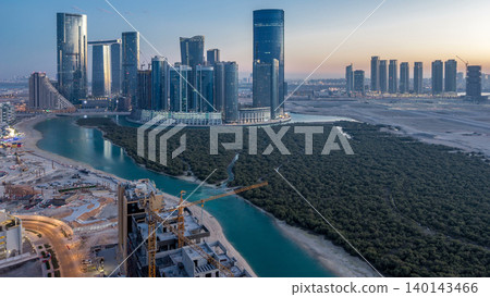 Buildings on Al Reem island in Abu Dhabi day to night timelapse from above. Buildings on Al Reem island in Abu Dhabi day to night timelapse from above. 140143466