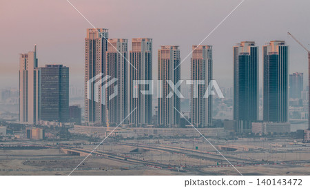 Buildings on Al Reem island in Abu Dhabi night to day timelapse from above. 140143472