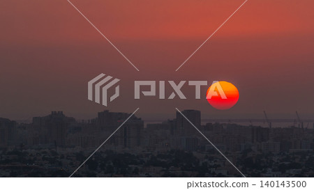 Sunset in Ajman aerial view from rooftop timelapse. United Arab Emirates. 140143500