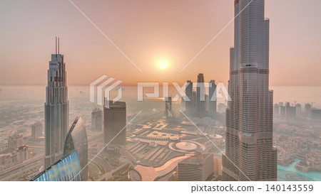 Panoramic skyline view of Dubai downtown during sunrise with mall, fountains and Burj Khalifa aerial morning timelapse Panoramic skyline view of Dubai downtown during sunrise with mall, fountains and Burj Khalifa aerial morning timelapse 140143559