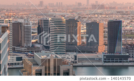 Dubai's business bay towers at evening aerial timelapse. 140143570