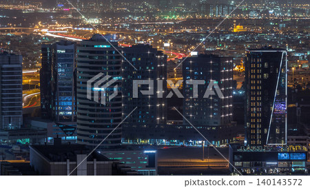 Dubai's business bay towers at evening aerial day to night timelapse. Dubai's business bay towers at evening aerial day to night timelapse. 140143572