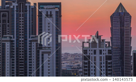 Sunset behind modern residential and office complex aerial timelapse at Business Bay, Dubai Sunset behind modern residential and office complex aerial timelapse at Business Bay, Dubai 140143573