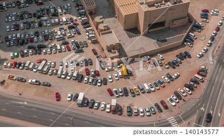 Aerial view full cars at large outdoor parking lots timelapse in Dubai, UAE. Aerial view full cars at large outdoor parking lots timelapse in Dubai, UAE. 140143577