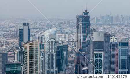 Dubai Downtown skyline futuristic cityscape with many skyscrapers and Burj Khalifa aerial night to day timelapse. Dubai Downtown skyline futuristic cityscape with many skyscrapers and Burj Khalifa aerial night to day timelapse. 140143579