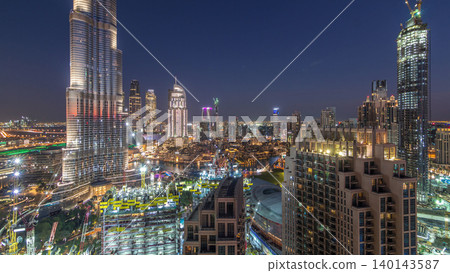 Panoramic skyline view of Dubai downtown after sunset with mall, fountains and skyscrapers aerial day to night timelapse Panoramic skyline view of Dubai downtown after sunset with mall, fountains and skyscrapers aerial day to night timelapse 140143587