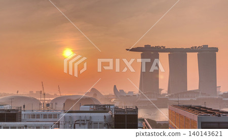 Sunrise near Marina Bay Sands Hotel dominates the skyline at Marina Bay in Singapore aerial timelapse. Sunrise near Marina Bay Sands Hotel dominates the skyline at Marina Bay in Singapore aerial timelapse. 140143621