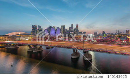 Aerial view over Helix Bridge and Bayfront Avenue with traffic day to night timelapse at Marina Bay, Singapore Aerial view over Helix Bridge and Bayfront Avenue with traffic day to night timelapse at Marina Bay, Singapore 140143625