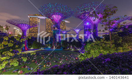 Futuristic aerial view of amazing illumination at Garden by the Bay day to night timelapse in Singapore. Futuristic aerial view of amazing illumination at Garden by the Bay day to night timelapse in Singapore. 140143641