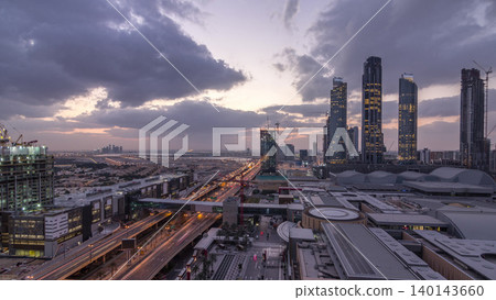 Aerial view of Financial center road night to day timelapse with under construction building Aerial view of Financial center road night to day timelapse with under construction building 140143660