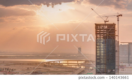 Sunrise aerial view of Financial center road morning timelapse with under construction building Sunrise aerial view of Financial center road morning timelapse with under construction building 140143661