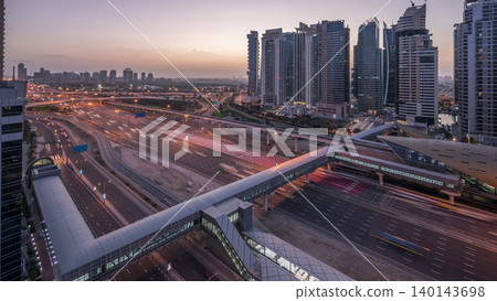 Aerial top view to Sheikh Zayed road near Dubai Marina and JLT night to day timelapse, Dubai. Aerial top view to Sheikh Zayed road near Dubai Marina and JLT night to day timelapse, Dubai. 140143698