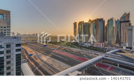 Aerial top view to Sheikh Zayed road during sunrise near Dubai Marina and JLT timelapse, Dubai. Aerial top view to Sheikh Zayed road during sunrise near Dubai Marina and JLT timelapse, Dubai. 140143701
