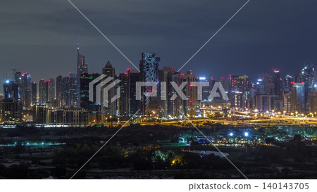 Jumeirah lake towers and Dubai marina skyscrapers and golf course during all night timelapse, Dubai, United Arab Emirates Jumeirah lake towers and Dubai marina skyscrapers and golf course during all night timelapse, Dubai, United Arab Emirates 140143705