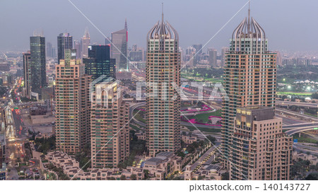 Aerial top view of Dubai Marina day to night timelapse. Modern towers and traffic on the road Aerial top view of Dubai Marina day to night timelapse. Modern towers and traffic on the road 140143727