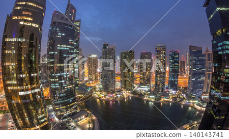 Residential and office buildings in Jumeirah lake towers district day to night timelapse in Dubai Residential and office buildings in Jumeirah lake towers district day to night timelapse in Dubai 140143741