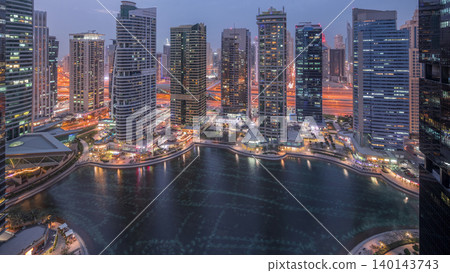 Residential and office buildings in Jumeirah lake towers district day to night timelapse in Dubai Residential and office buildings in Jumeirah lake towers district day to night timelapse in Dubai 140143743