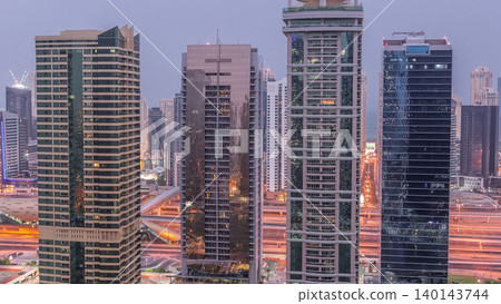 Residential and office buildings in Jumeirah lake towers district night to day timelapse in Dubai Residential and office buildings in Jumeirah lake towers district night to day timelapse in Dubai 140143744