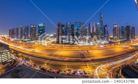 Aerial view of Jumeirah lakes towers skyscrapers day to night timelapse with traffic on sheikh zayed road. Aerial view of Jumeirah lakes towers skyscrapers day to night timelapse with traffic on sheikh zayed road. 140143796