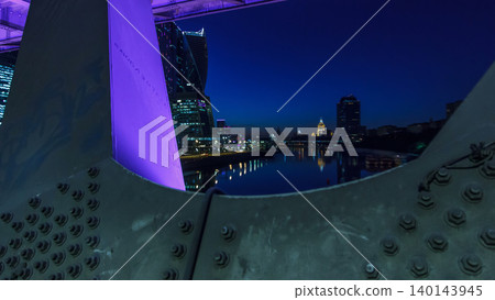 Moscow river near the skyscrapers of Moskva City district in the night timelapse view under the bridge. Moscow river near the skyscrapers of Moskva City district in the night timelapse view under the bridge. 140143945