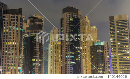 Evening Dubai marina city center with floating vessels day to night timelapse Evening Dubai marina city center with floating vessels day to night timelapse 140144026