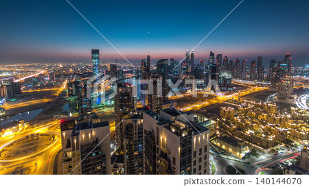 Aerial view of a big modern city day to night timelapse. Business bay, Dubai, United Arab Emirates. Aerial view of a big modern city day to night timelapse. Business bay, Dubai, United Arab Emirates. 140144070