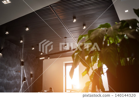 Office room with blank computer display,table,chair,cement floor,glass walls with night city view. Sunlight . 140144320