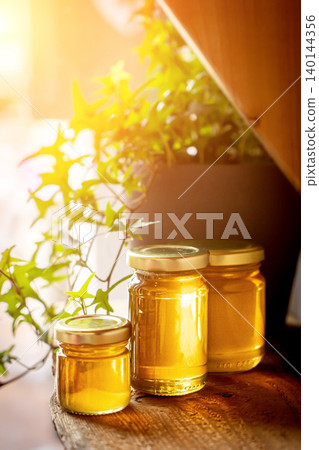 Jars of different honey varieties stocked on a shelf Jars of different honey varieties stocked on a shelf 140144356