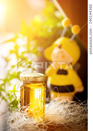 Natural honey in various jars on a wooden shelf, souvenir village market. Natural honey in various jars on a wooden shelf, souvenir village market. 140144360