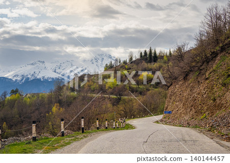 Winding road curves through spring hills. Svaneti region Winding road curves through spring hills. Svaneti region 140144457