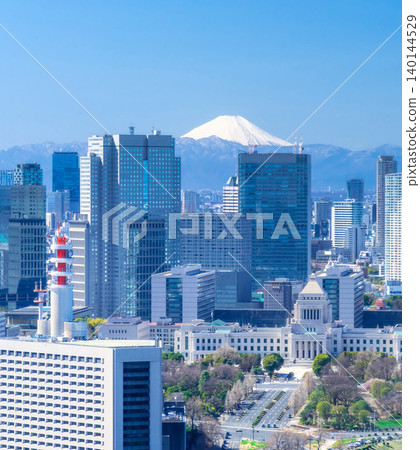 The cityscape of central Tokyo and Mount Fuji spread out under a blue sky. The cityscape of central Tokyo and Mount Fuji spread out under a blue sky. 140144529