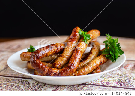 traditional grilled sausages in bowl on wooden table traditional grilled sausages in bowl on wooden table 140144845
