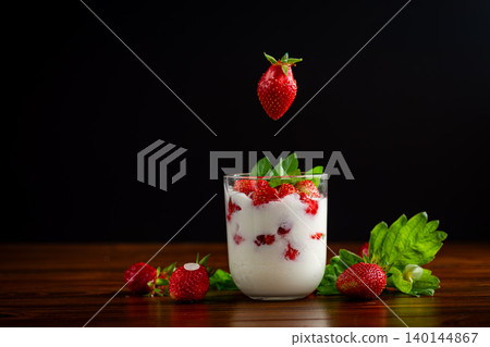 Sweet berry dessert with white cream and mint Sweet berry dessert with white cream and mint 140144867