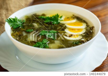 Ukrainian green borscht with sliced boiled eggs 140144879