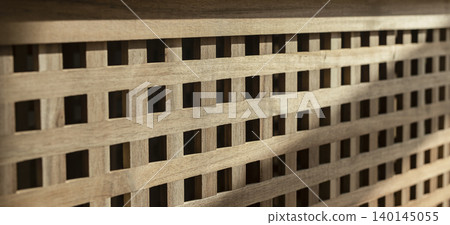 Wooden lattice panel close up. Acacia wood storage furniture with decorative grid pattern. Interior design texture for rustic decor and background.. 140145055