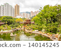 Ancient Wooden Pavilion on a Pond and Hong Kongs Skyscrapers 140145245