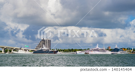 Luxury yacht docked in port of Miami. Miami south beach, Florida. Waterfront view of port with boats. Miami port with ship and yacht boat. Marina landscape. Summer travel and vacation. Boat trip 140145404