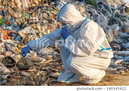 Dedicated environmentalist investigates landfill pollution, highlighting the urgent need for clean-up initiatives in a sunlit, cluttered landscape Dedicated environmentalist investigates landfill pollution, highlighting the urgent need for clean-up initiatives in a sunlit, cluttered landscape 140145422