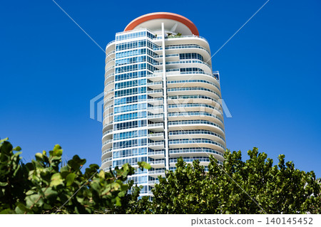 Hotel architecture. Architecture of modern building. Perspective residential skyscraper. Modern skyscraper building. Architectural building in Miami beach. Skyscraper in perspective view 140145452