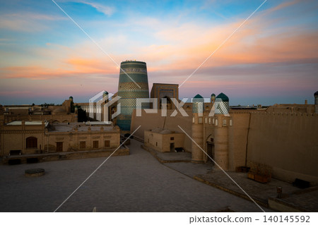 Uzbekistan's World Heritage Sites of Khiva and Kaltamine bathed in the beautiful sunrise. 140145592