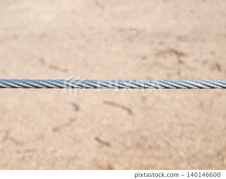 Abstract texture of a metal cable railing on a beach in summer. Abstract texture of a metal cable railing on a beach in summer. 140146600