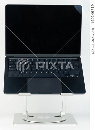 Open laptop on metal desk support Open laptop on metal desk support 140146719