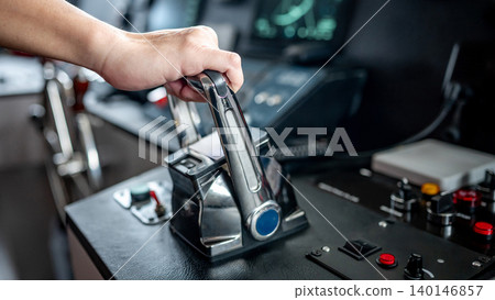 Captain hand holding throttle control or engine control lever on boat dashboard Captain hand holding throttle control or engine control lever on boat dashboard 140146857