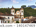 Church tower emerging among the houses 140147469