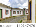 Cobblestone street with a small chapel 140147470