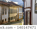 Colonial houses on a cobblestone street 140147471